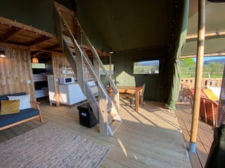 Rosa Lodge living area with loft ladders to access mezzanine level