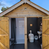 Outdoor wash hut with shower side and compost toilet